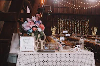 a wedding reception table in a barn